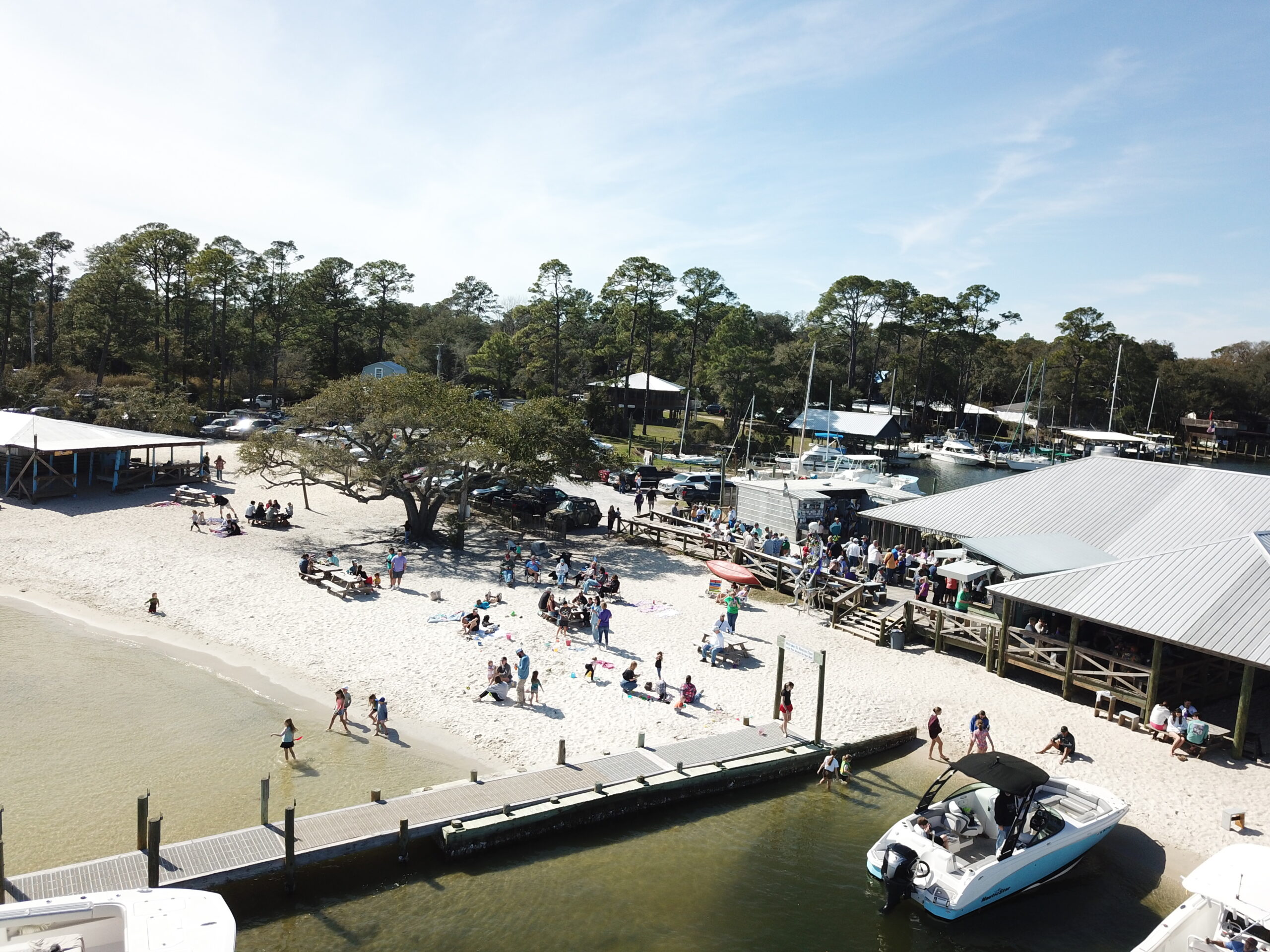 Overview of pirates cove. People hanging out having fun listening to live music eating cheeseburgers and drinking bushwackers