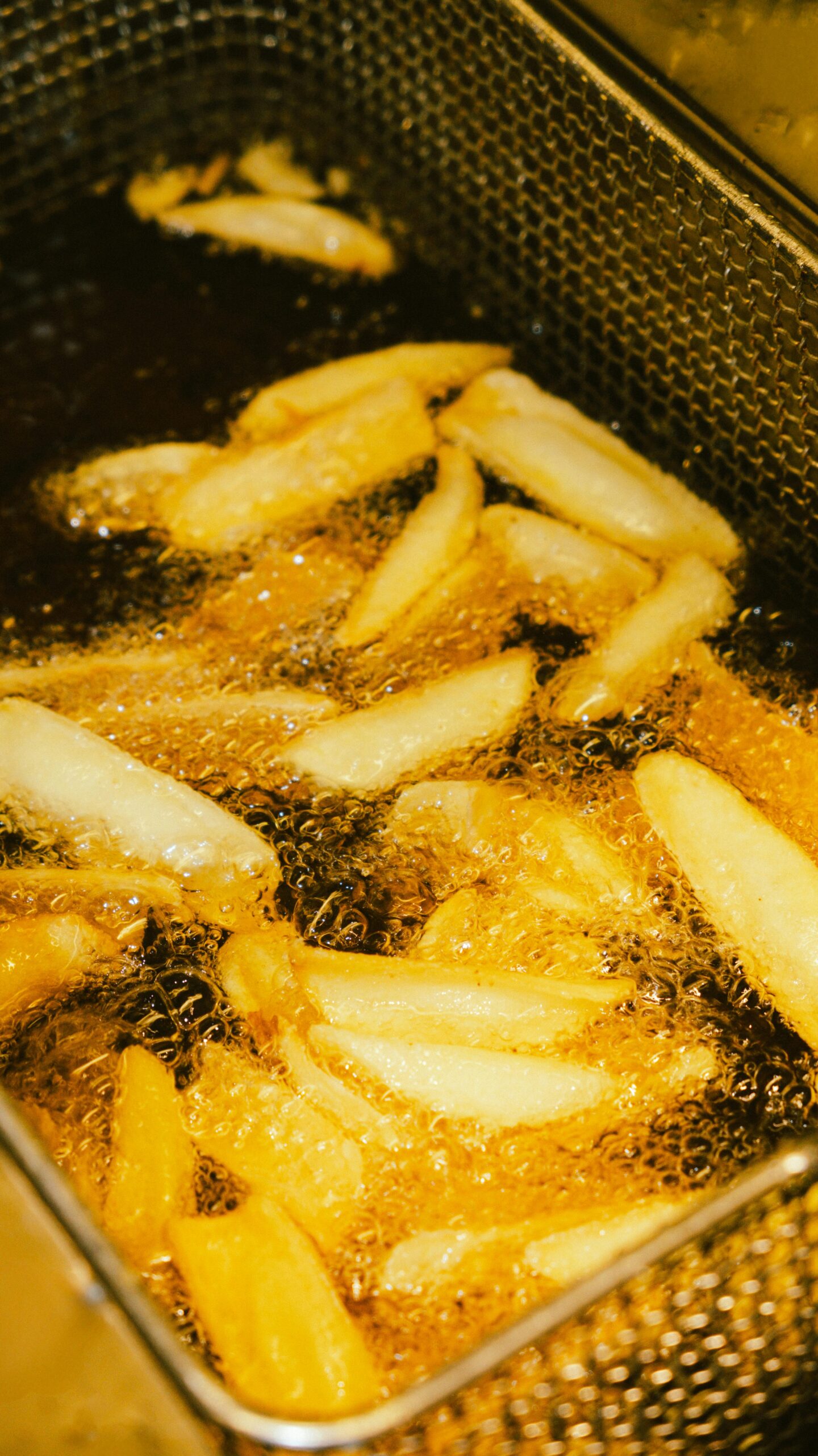 pexels-photo-31701973-31701973 - Pirates Cove | Iconic Gulf Coast Bar & Grill with Drinks, Food & Live Music Frying French fries in oil